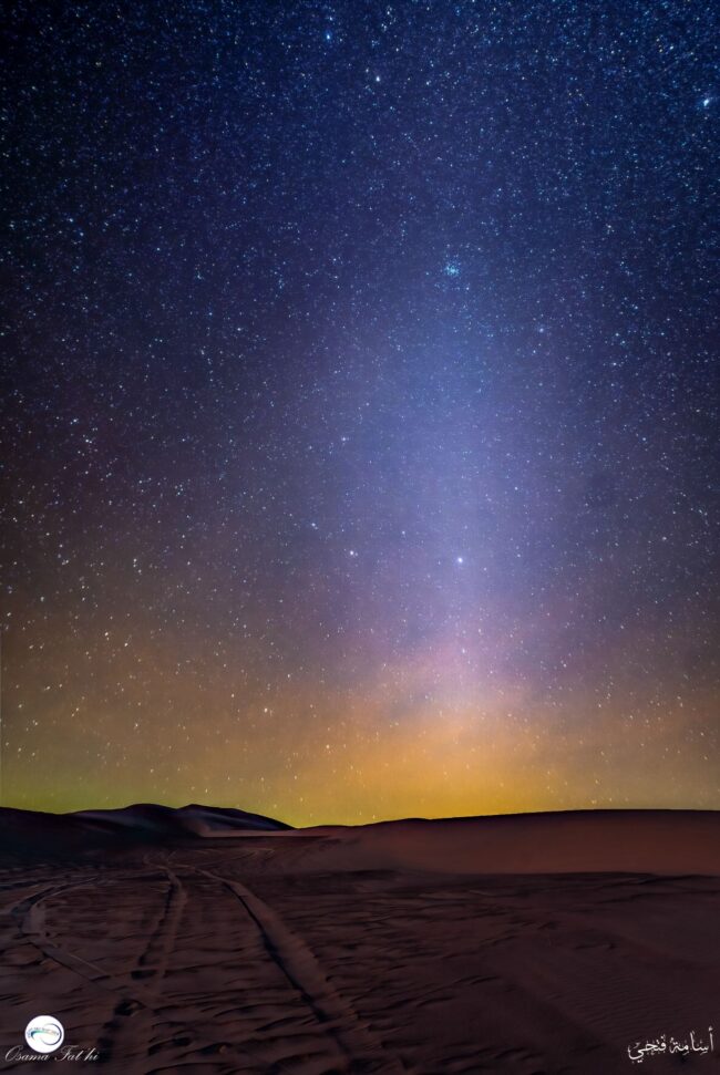 Night sky with a lighter pattern extending upward from the horizon.