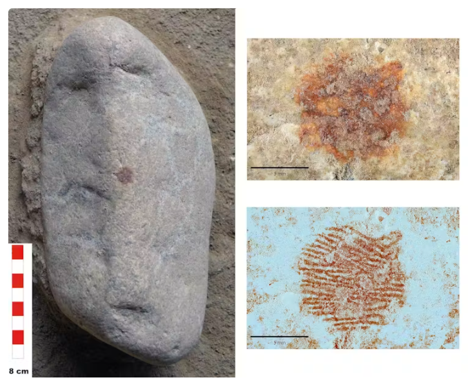 Rock with features like a human face and a red spot in the center. Closeups of the spot.