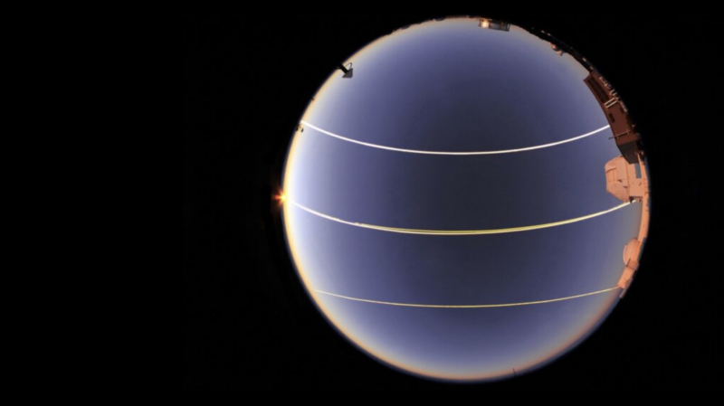 View of the full sky with 3 lines crossing it. 