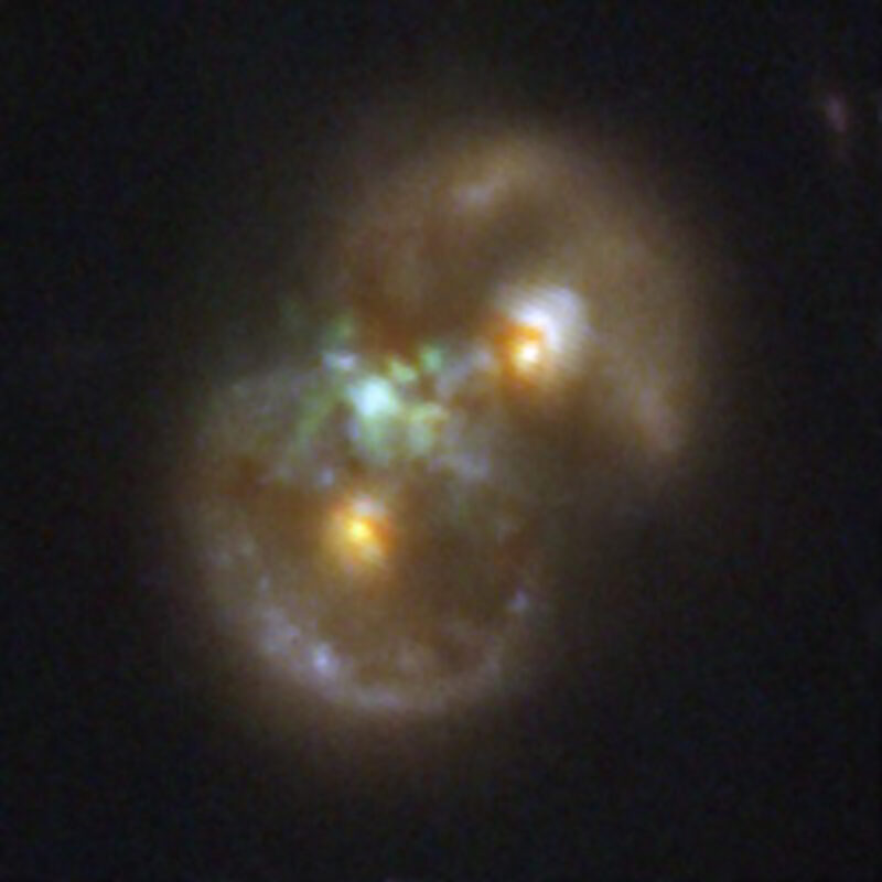 Black hole: Two yellowish cores or light with a light blue area between them and sweeps of gas and dust in circles around both.