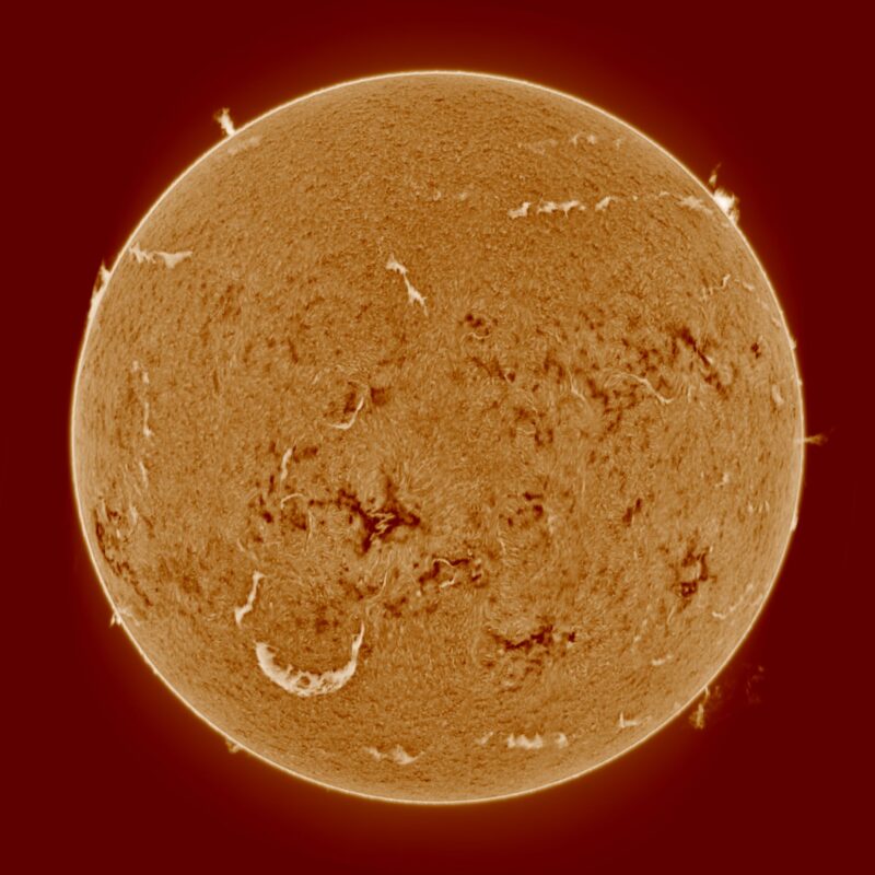 The sun, seen as a large yellow sphere with a mottled surface.