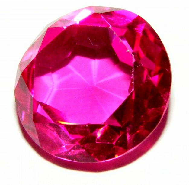 A round, red faceted jewel.