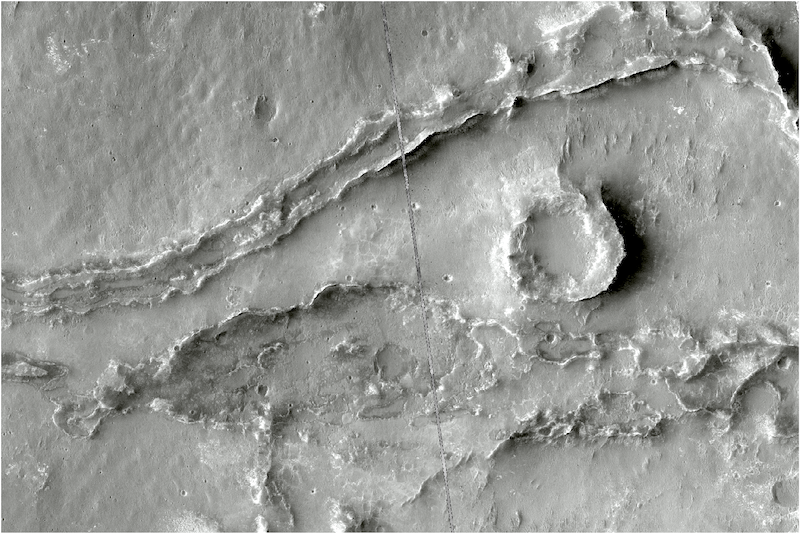 Gray terrain with long, meandering ridges and a smaller circular ridge next to them.