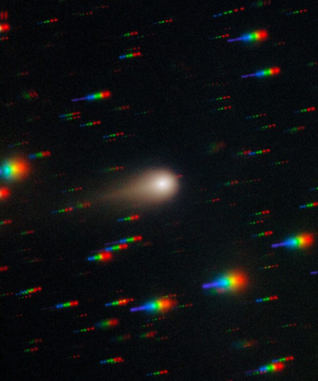 Many short streaks in rainbow colors, and a larger, round, fuzzy white object with a tail.