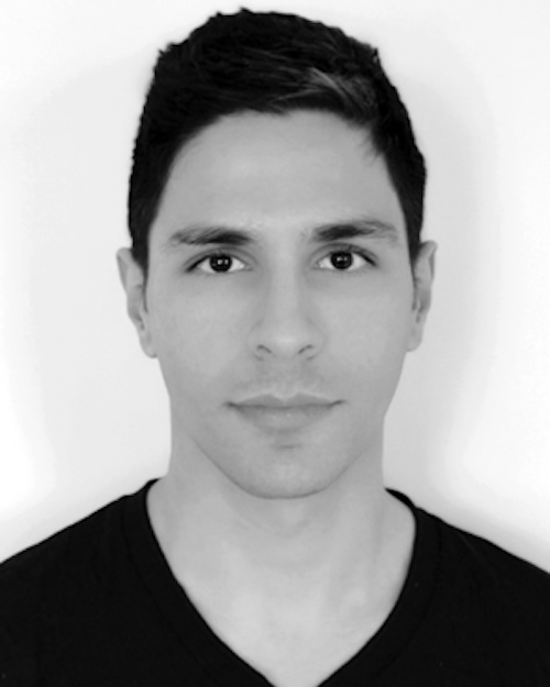 Black and white image of a young man with dark hair and dark t-shirt.
