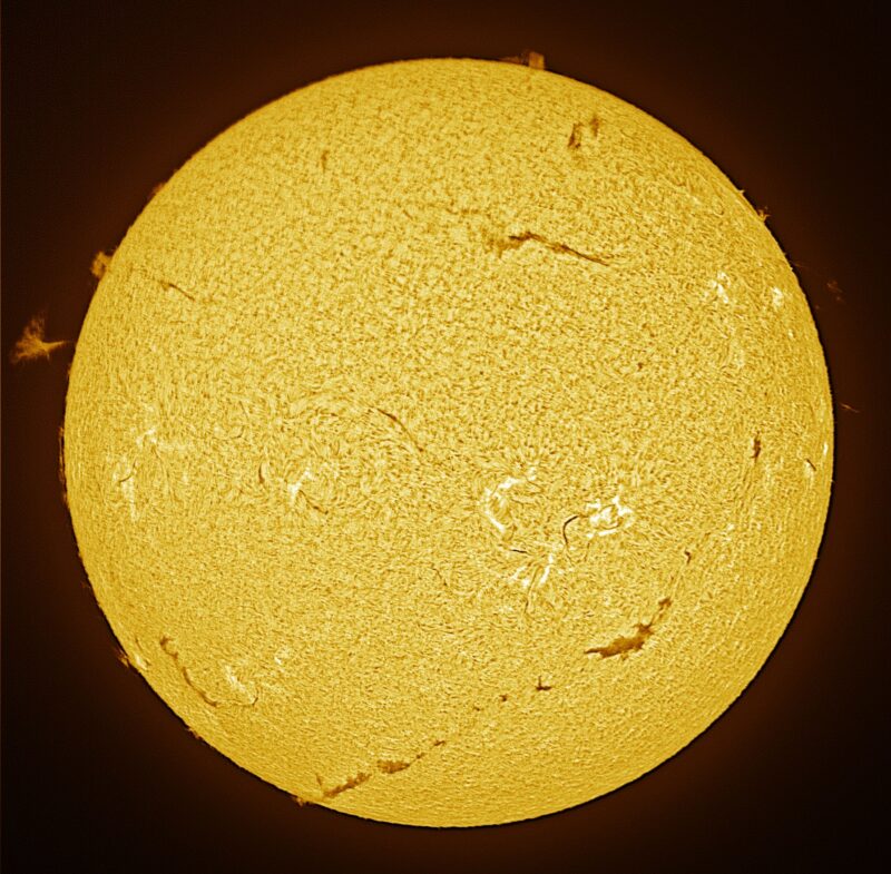 The sun, seen as a large yellow sphere with a mottled surface.