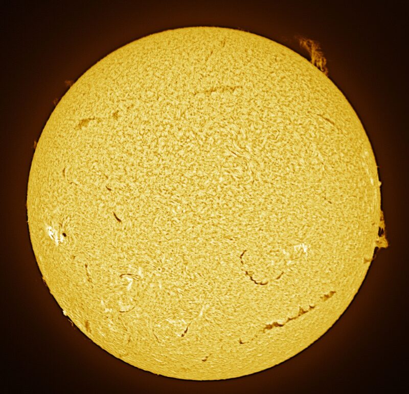 The sun, seen as a large yellow sphere with a mottled surface.