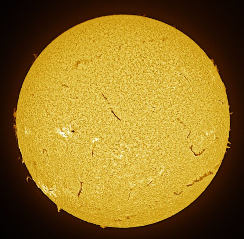 The sun, seen as a large yellow sphere with a mottled surface.