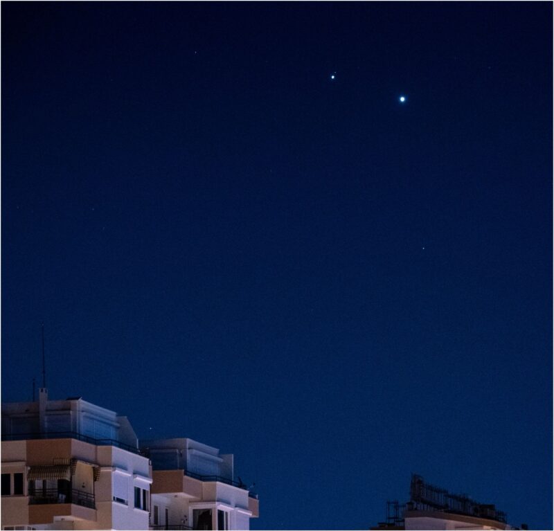 Blue sky with 2 bright dots. There are other smaller dots next to the dot to the far left.
