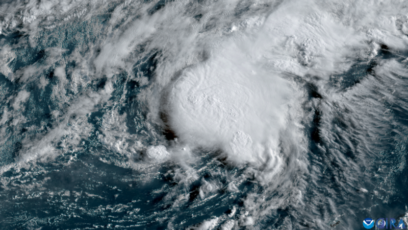 A swirl of thick white clouds over the blue waters of the Atlantic Ocean.