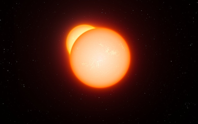 Binary stars: Two yellow-orange glowing spheres in space, one partly hidden behind the other.