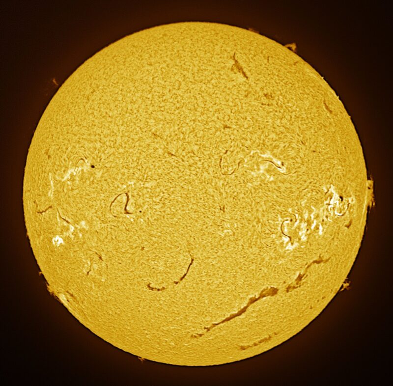 The sun, seen as a large yellow sphere with a mottled surface.