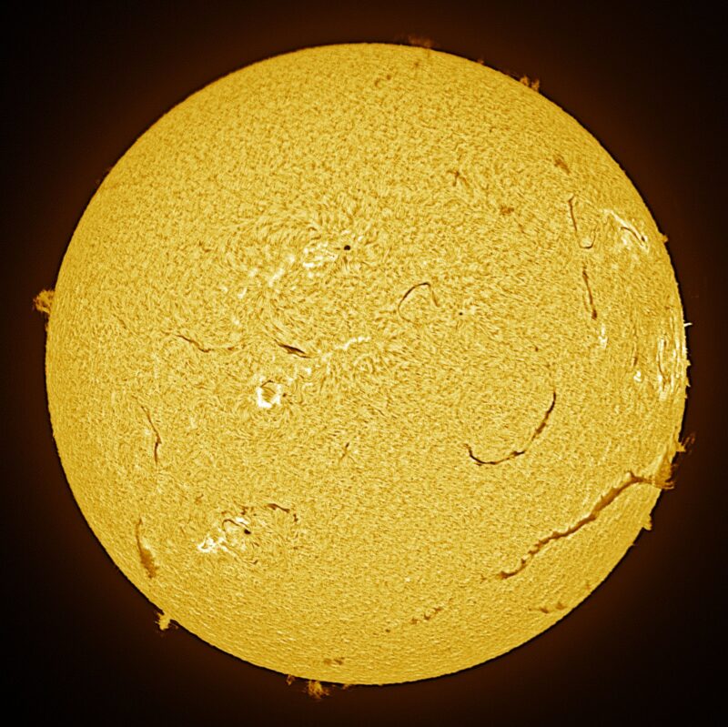 The sun, seen as a large yellow sphere with a mottled surface.