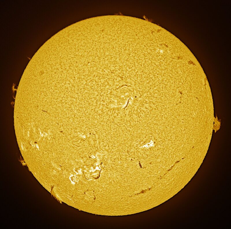The sun, seen as a large yellow sphere with a mottled surface.