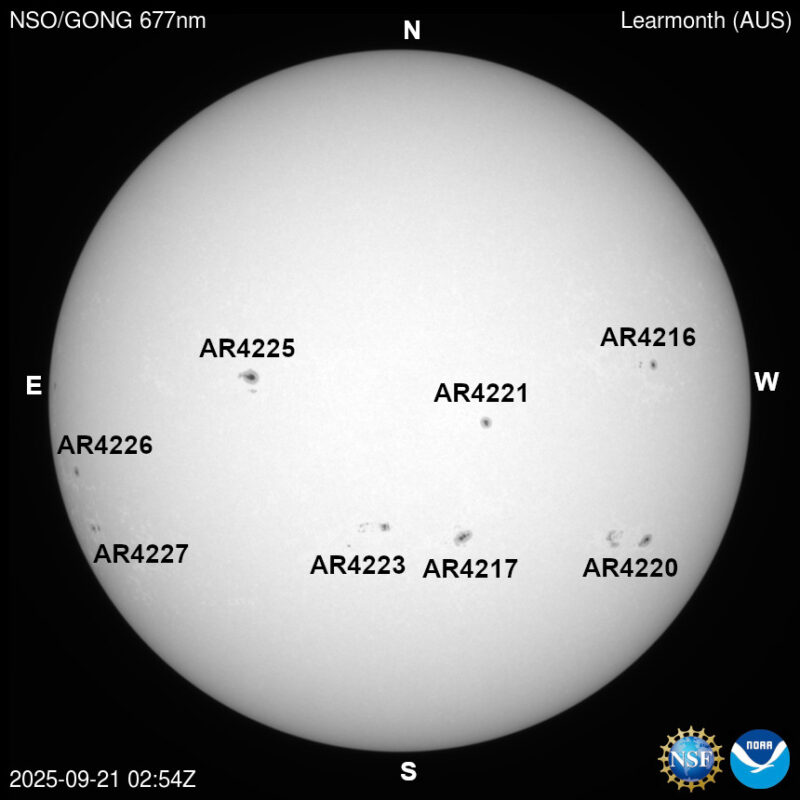 The sun, seen as a large white sphere with dark spots, each labeled.