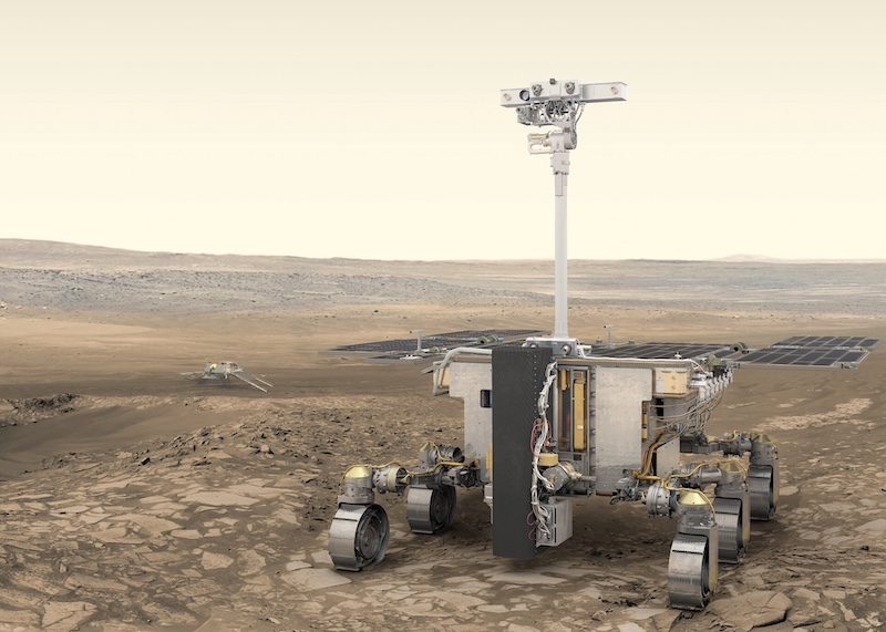 Rosalind Franklin rover: Robotic rover with 6 wheels and tall mast in the front, on brownish flat terrain. A smaller platform with ramp is is the distance.