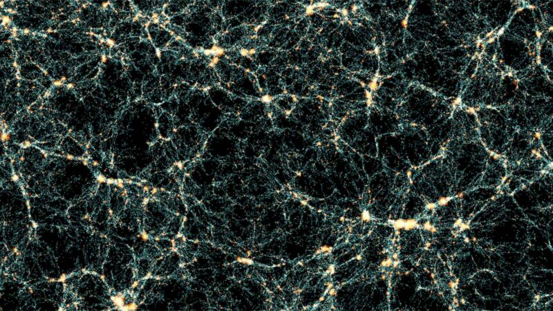 Universe simulation: On a black background, a complex web of interconnected branching lines made up of tiny blue dots, with concentrations of red dots at particularly busy nodes.