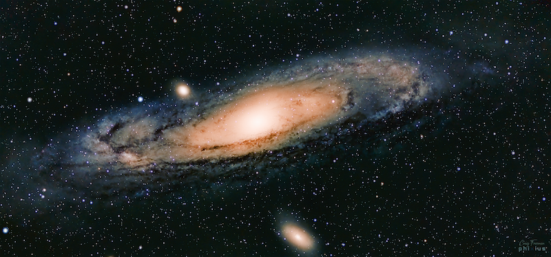 A very detailed glowing spiral in space seen obliquely in a starfield.