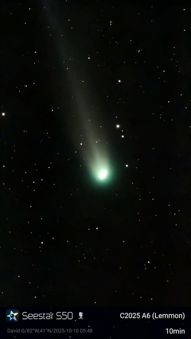 Glowing coma of Comet Lemmon with a short, diffuse tail streaming away from it.