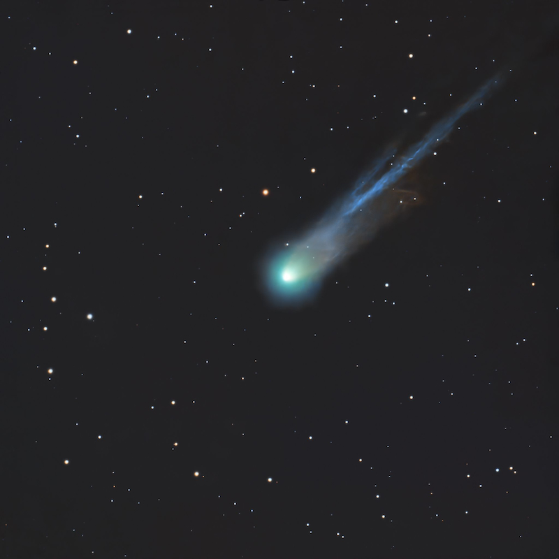Fuzzy glowing ball in a starfield with a long tail.