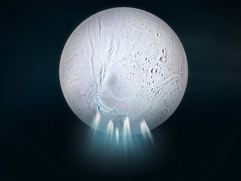 Organics in Enceladus' ocean: Planet-like body that is whitish and mostly smooth, with some craters and cracks. Several large plumes are erupting from the surface at the bottom.