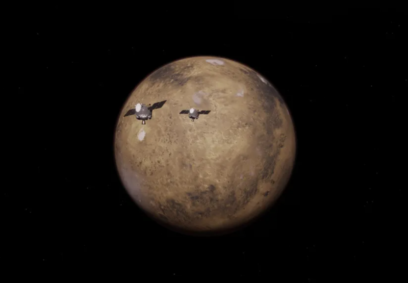 Artwork of a brownish planet and 2 space probes headed there.