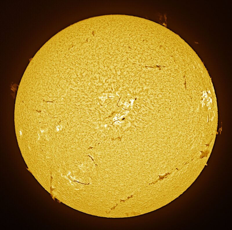 The sun, seen as a large yellow sphere with a mottled surface.