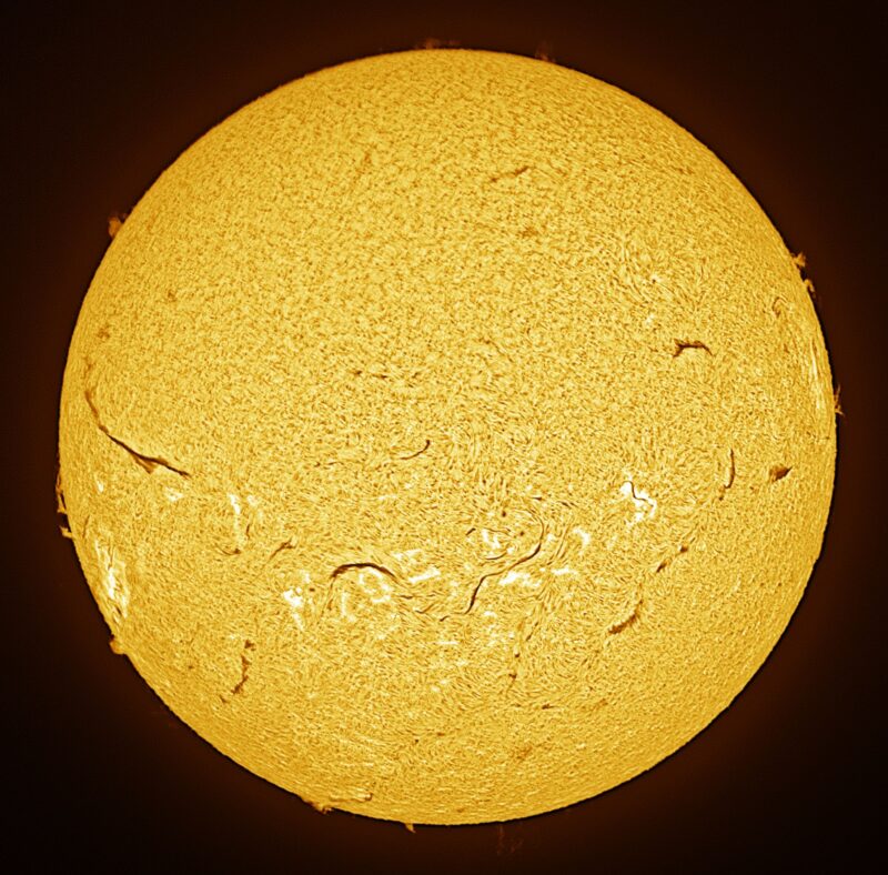 The sun, seen as a large yellow sphere with a mottled surface.