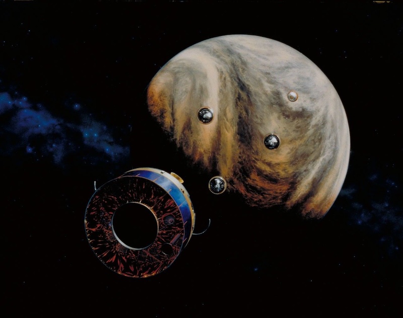 Water in Venus' clouds: 1 large and 4 small spacecraft approaching a planet with swirling clouds.