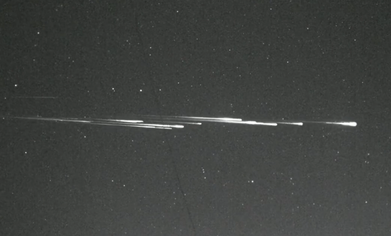 Bright streaks of light across a starry background.
