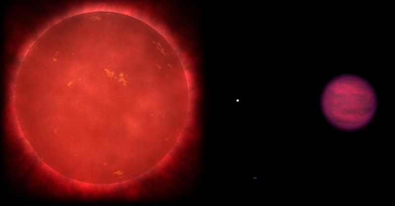 Phosphine on brown dwarf: Large reddish sphere on the left, tiny white dot in the middle and larger brownish sphere on the right, on black background.