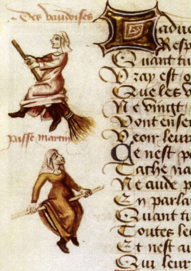 Marginalia showing 2 women riding broomsticks.
