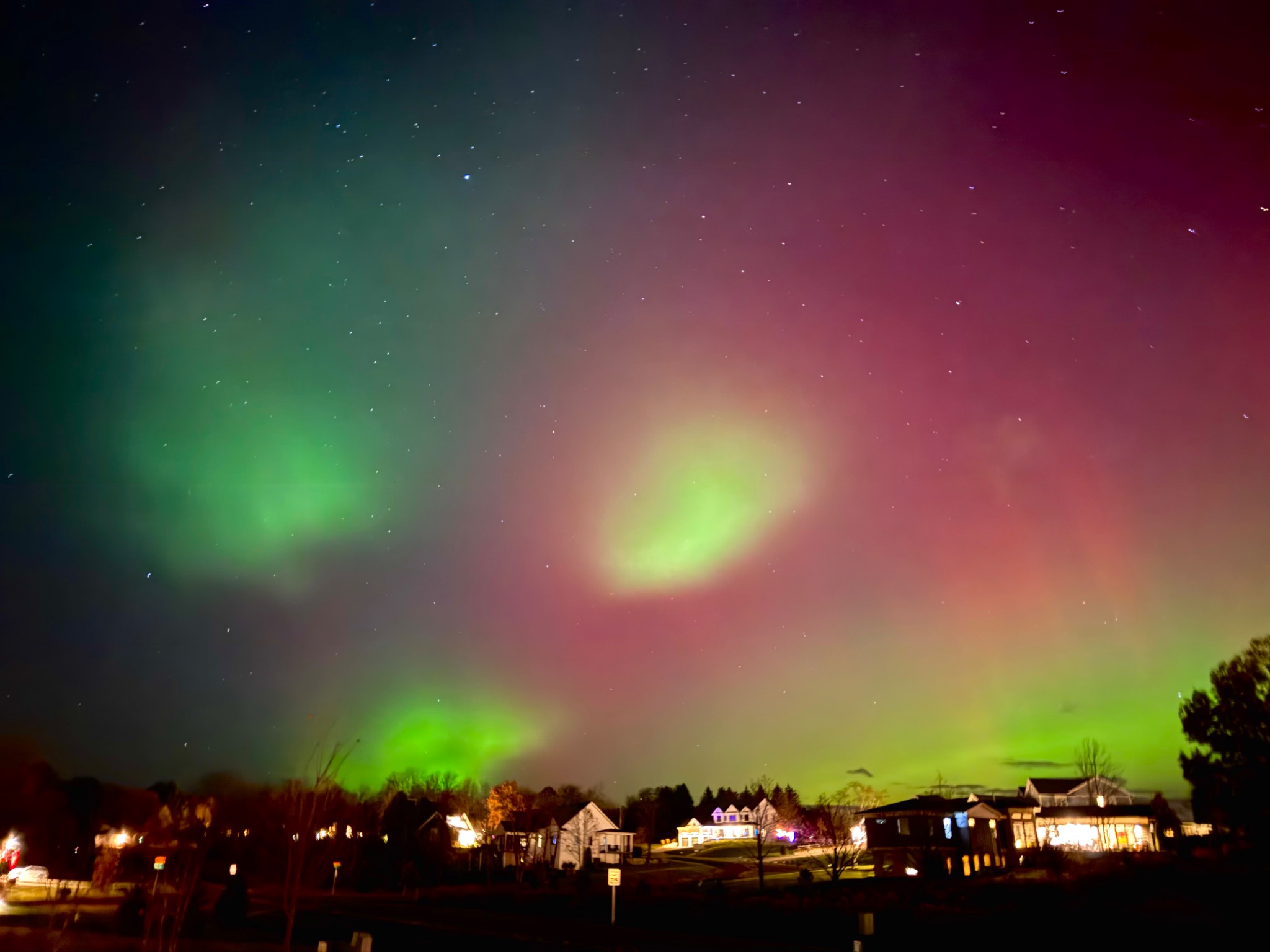 Background red aurora with bright green blobs.