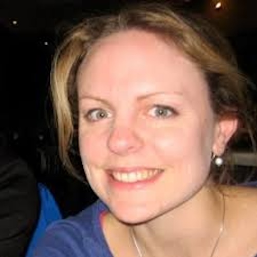 Smiling woman wearing a blue shirt.