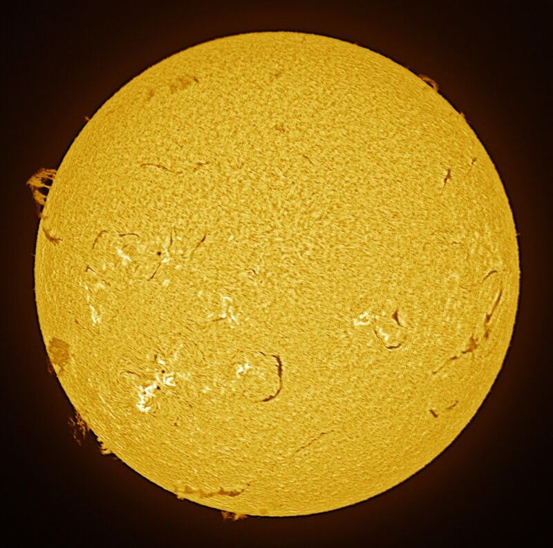 A sun close-up, seen as a flat square yellow surface with a mottled surface.