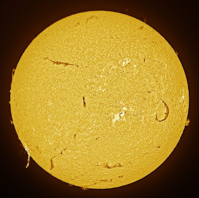 A sun close-up, seen as a flat square yellow surface with a mottled surface.