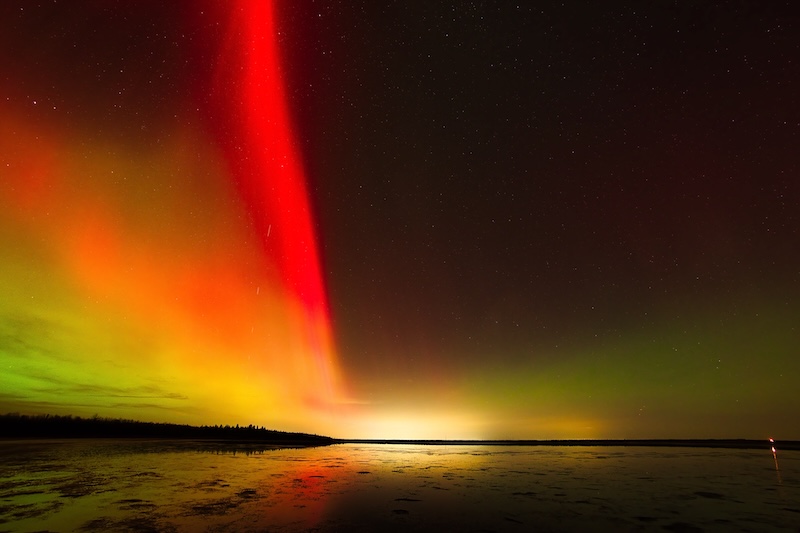 Left half of the sky filled with glowing red and the right half dark.