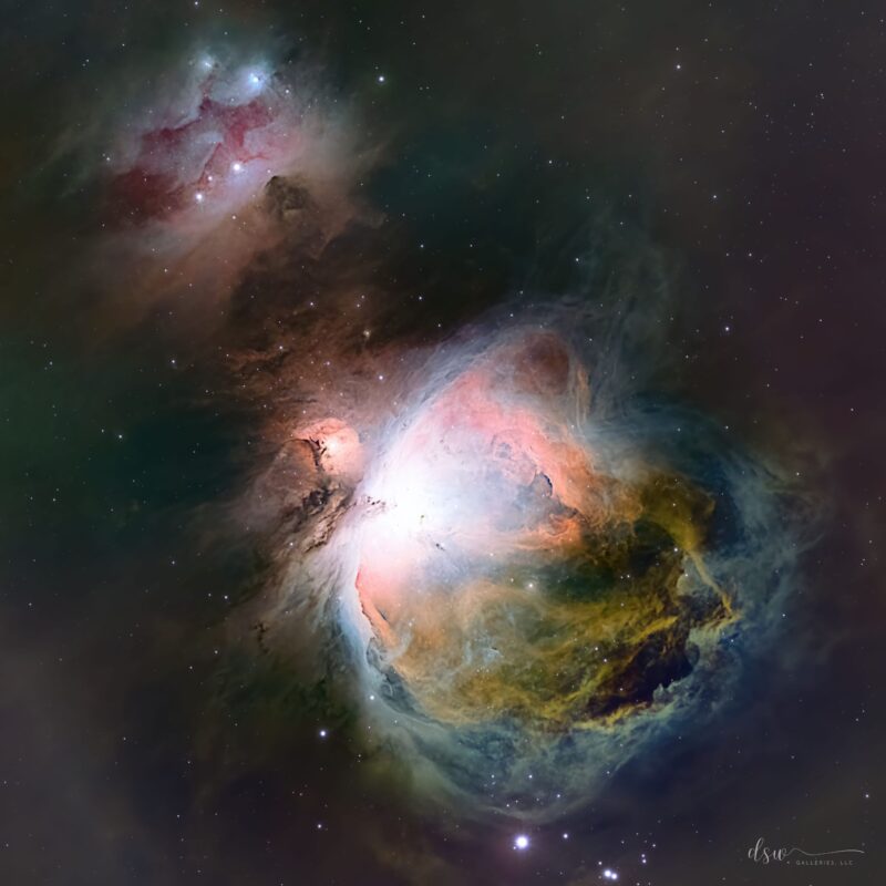 Crisply outlined swirls of 3 glowing, multicolored gas clouds with stars embedded in them.