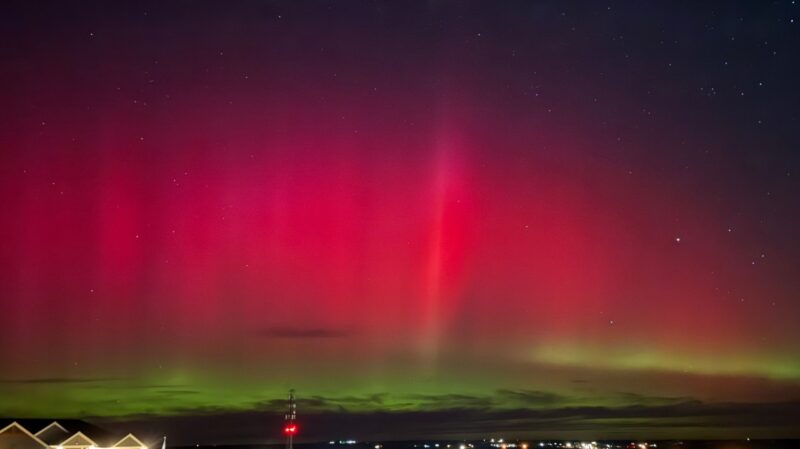 Red curtains of aurora with green at the base.