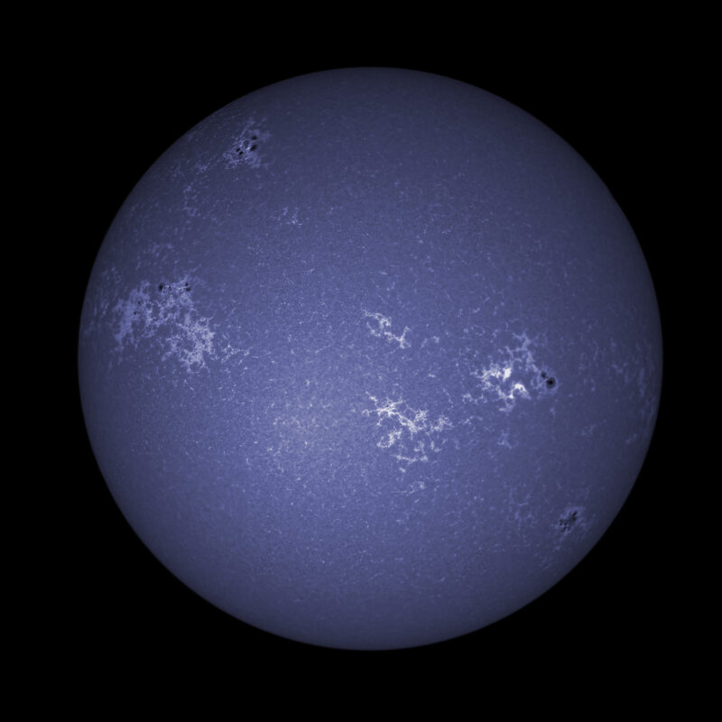 The sun, seen as a large blue sphere with a mottled surface.