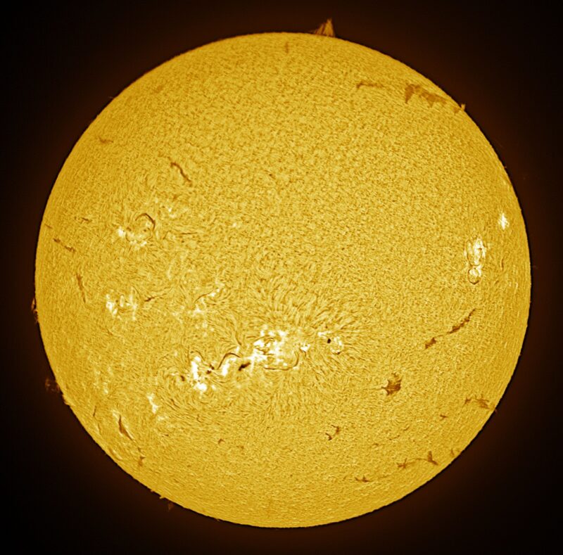 A sun close-up, seen as a flat square yellow surface with a mottled surface.