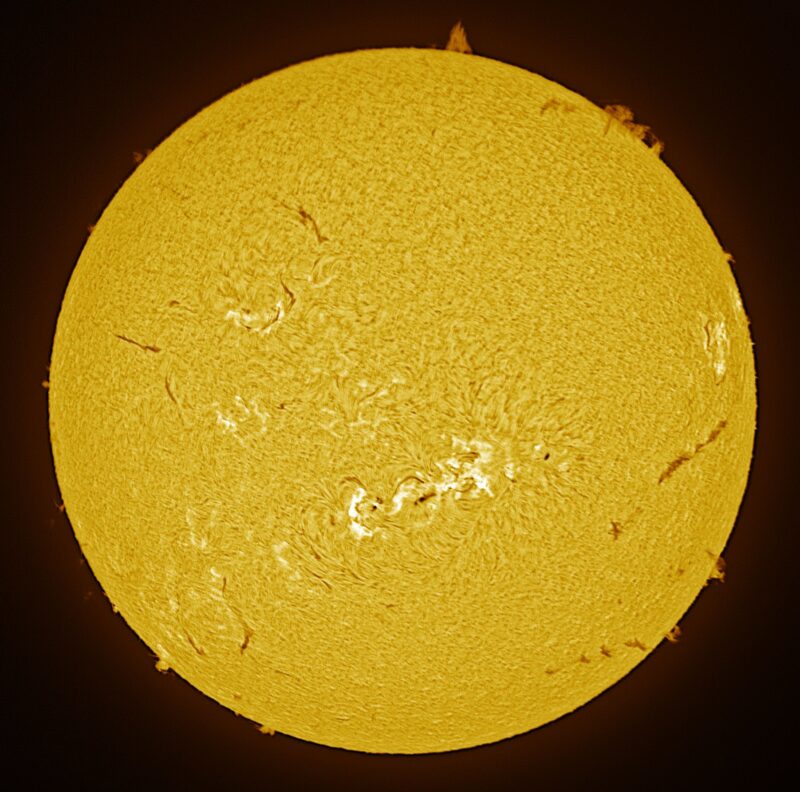 The sun, seen as a large yellow sphere with a mottled surface.