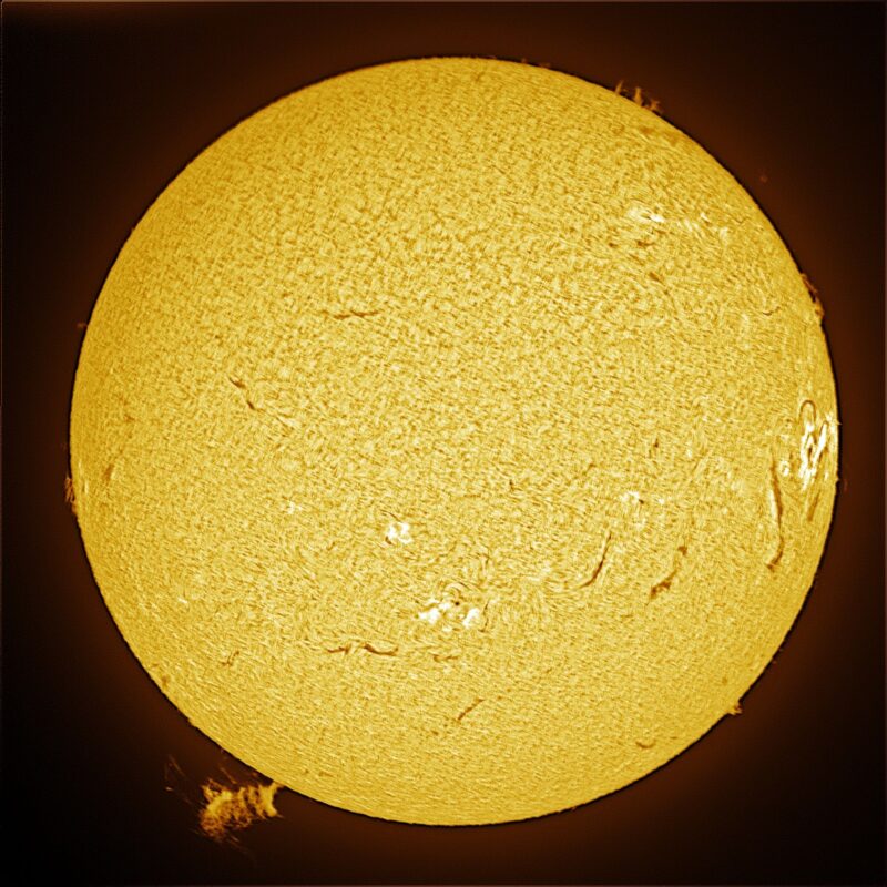 The sun, seen as a large yellow sphere with a mottled surface.