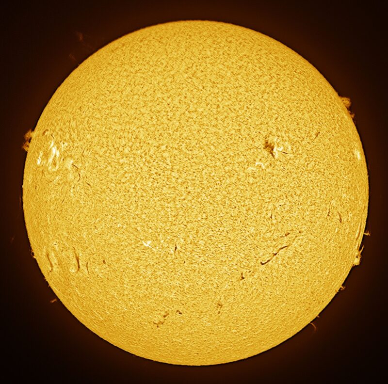 The sun, seen as a large yellow sphere with a mottled surface.