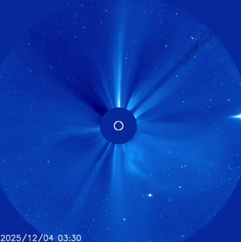 Bright white dot of Venus moving on blue background. At the center of the image, the sun is obscured by a disk.