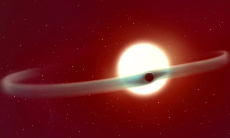Planet with double tail: Planet silhouetted in front of a bright white star. 2 long curving tails of gas are coming off the planet, one on each side.