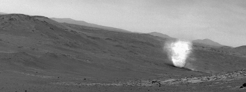 Small spirals of dust rotating in a dry, dusty area.