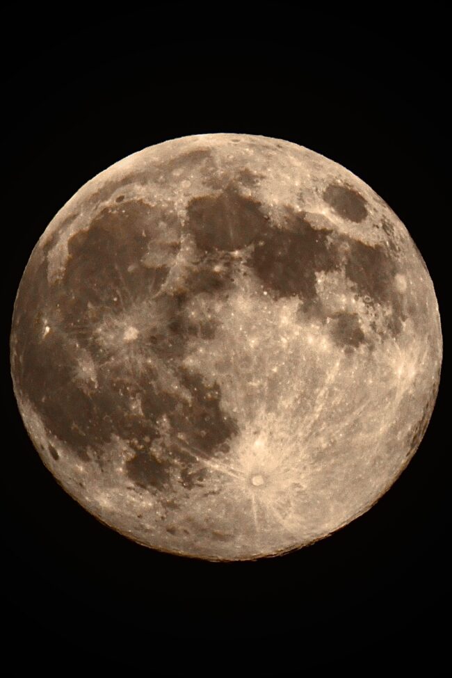A full moon with a sepia-toned tinge.