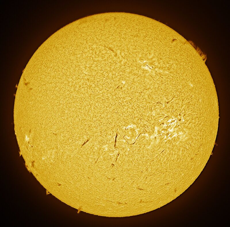 The sun, seen as a large yellow sphere with a mottled surface.
