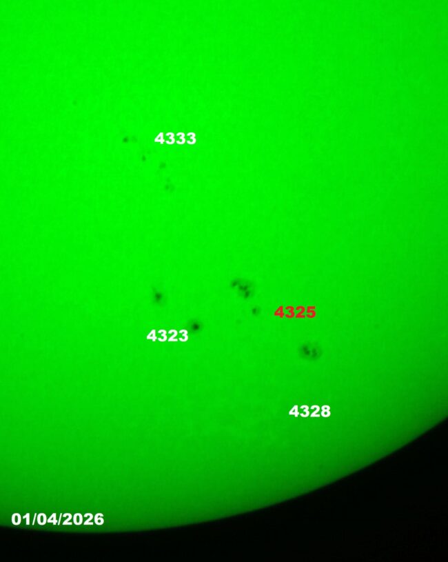 The sun, seen as a green sectional sphere with dark spots.
